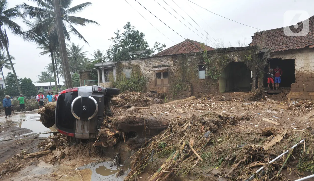 Sebuah mobil terguling usai banjir bandang melanda Kampung Cibuntu, Desa Pasawahan, Kecamatan Cicurug, Sukabumi, Jawa Barat, Selasa (22/9/2020). Data sementara puluhan bangunan rusak berat, 12 rumah hanyut, dan dua korban hilang masih dicari. (merdeka.com/Arie Basuki)