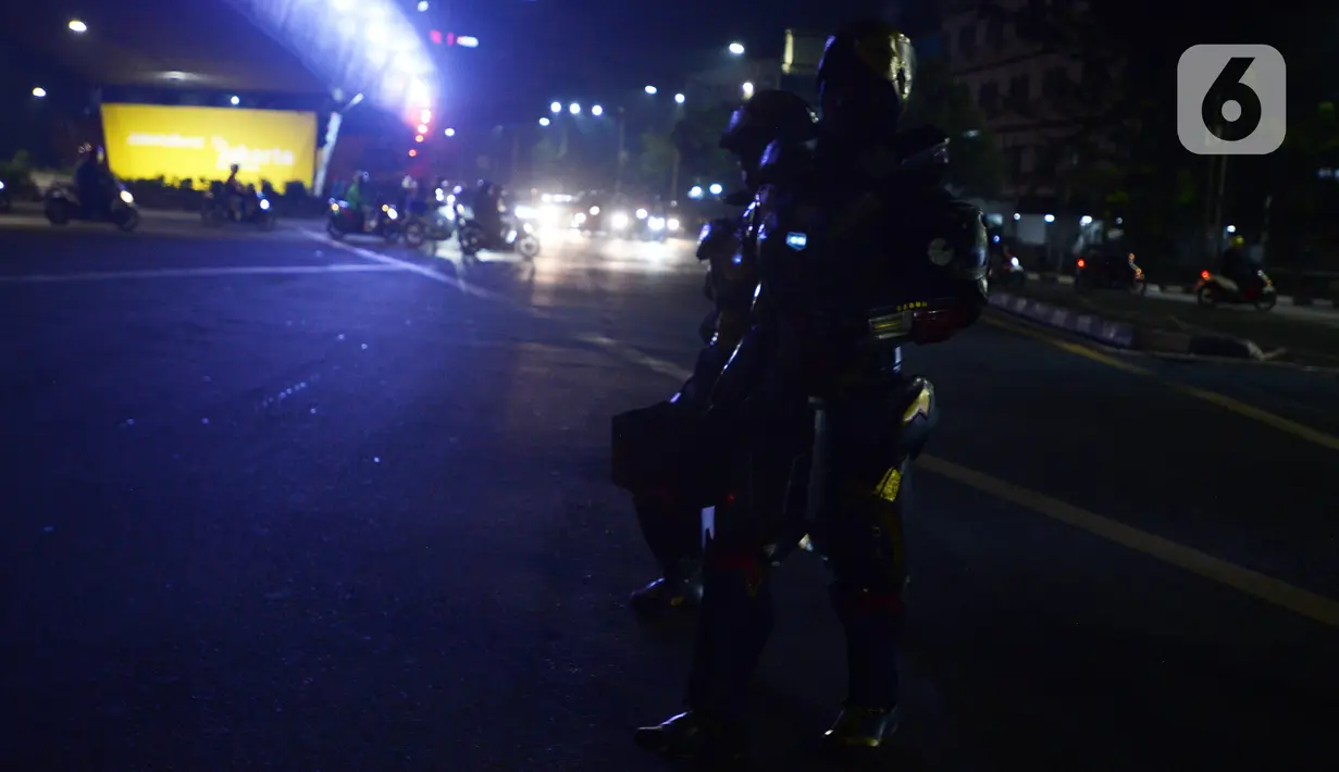 Dua robot saat menghibur pengendara di kawasan Tomang, Jakarta, Selasa (14/9/2021). Abi (20) dan Nujum (48) mengenakan kostum robot Iron Man untuk mengais rejeki dan menghibur para pengendara dari kemacetan lalu lintas yang dilakukan sejak pandemi COVID-19. (merdeka.com/Imam Buhori)