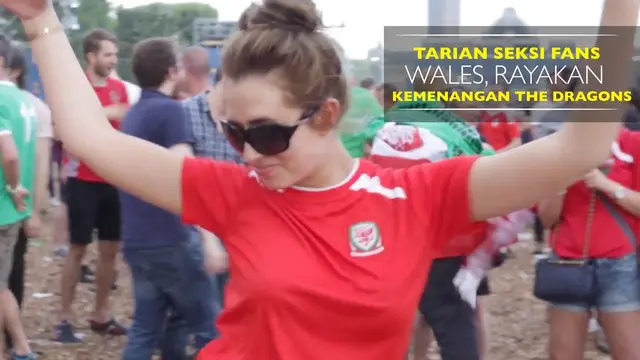 Seorang fans cantik bergoyang di tengah area Fanzone di kota Paris untuk merayakan kemenangan Wales.
