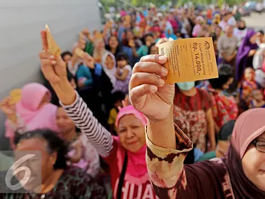 Warga menunjukkan kupon minyak goreng murah pada acara Bazar Rakyat di Rusun Marunda, Jakarta Utara, Kamis (30/6).Sepanjang tahun 2016 Sinar Mas telah menyalurkan sekitar 310 ribu liter minyak goreng kemasan. (Liputan6.com/Angga Yuniar)