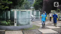 Petugas menyemprotkan cairan disinfektan di Taman Komodo TMII, Jakarta, Rabu (18/3/2020). Penyemprotan dilakukan untuk mengantisipasi penyebaran virus corona COVID-19. (Liputan6.com/Faizal Fanani)