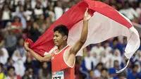 Purnomo Sapto Yogo pelari Indonesia meraih medali emas di nomor 100 meter putra klasifikasi T37 pada Asian Para Games 2018, di Stadion Utama Gelora Bung Karno Jakarta, Selasa (9/10/2018).  (Bola.com/Peksi Cahyo)