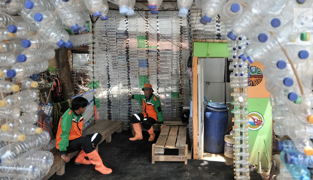 Petugas UPK Badan Air DLH DKI Jakarta bersantai dalam Pos Botol Plastik di Pasar Rebo, Jakarta, Selasa (12/3). Petugas memanfaatkan botol plastik bekas untuk membangun pos cantik. (merdeka.com/Iqbal Nugroho)
