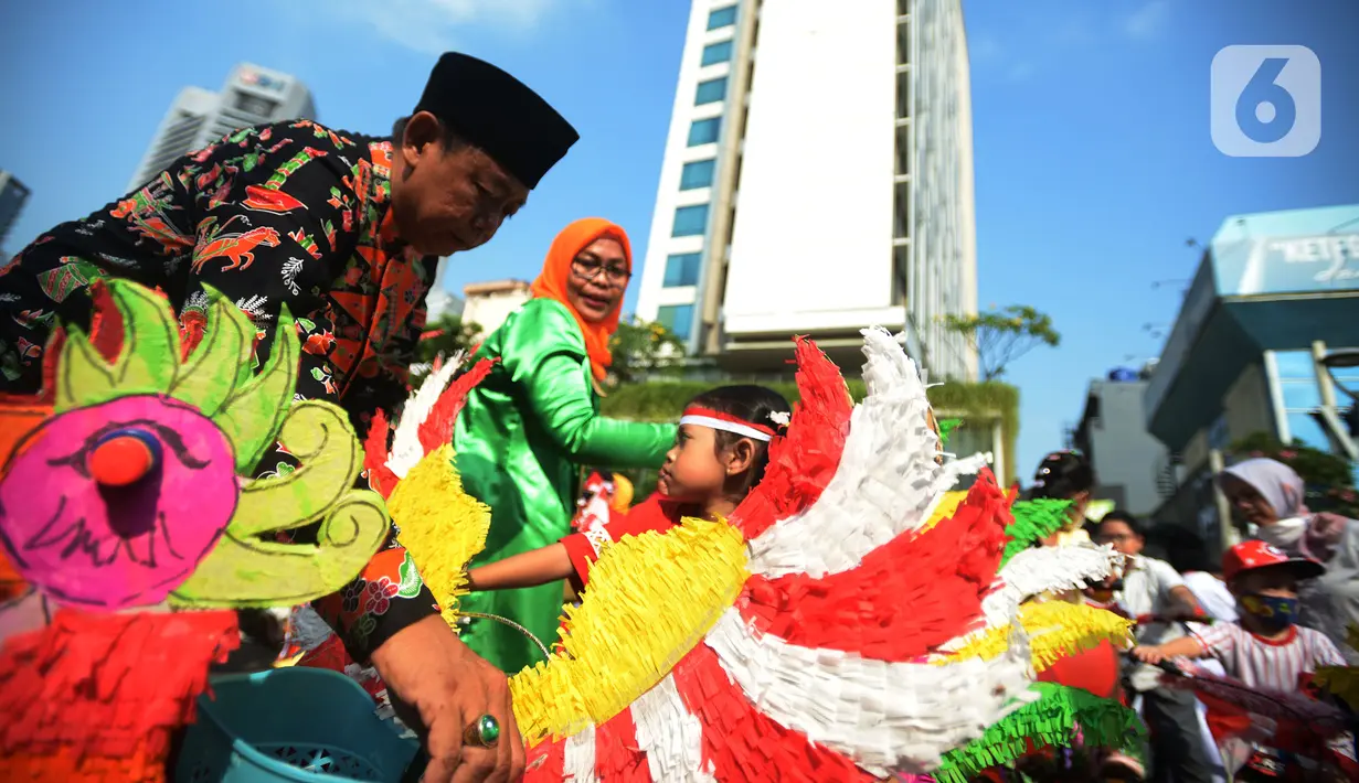 Anak-anak RW 04 Kebun Melati mengikuti karnaval sepeda hias saat pelaksanaan upacara Hari Ulang Tahun ke-77 Republik Indonesia di Jakarta, Rabu (17/8/2022). Peringatan Hari Ulang Tahun Republik Indonesia telah menjadi tradisi di kampung tersebut sejak tahun 1975. (merdeka.com/Imam Buhori)
