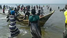 Sejumlah korban selamat dari insiden kapal tenggelam kembali ke darat di Danau Albert, Butiaba, Uganda, Senin (26/12). Setidaknya 30 orang dipastikan menjadi korban dalam insiden tersebut, yang di antaranya terdapat pesepakbola dalam satu tim. (AFP Photo)