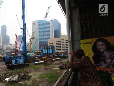 Seorang pria melihat proyek pembangunan Pasar Benhil di Jakarta, Kamis (29/11). Pasar Bendungan Hilir nantinya akan terintegrasi dengan transportasi massal MRT dan ditargetkan rampung pada tahun 2019. (Merdeka.com/Imam Buhori)