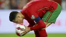 Penyerang Portugal Cristiano Ronaldo mencium bola sebelum melakukan tendangan penalti ke gawang Luksemburg pada lanjutan Kualifikasi Piala Dunia 2022 di Stadion Do Algarve, Rabu (13/10/2021) dini hari WIB. Hat-trick Ronaldo membuat Portugal menang 5-0 atas Luksemburg. (AP Photo/Joao Matos)