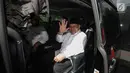 Gubernur Maluku Utara Abdul Ghani menyapa awak media saat berada di dalam mobil usai melakukan pertemuan membahas penyusunan APBD Maluku Utara Tahun 2018 di Gedung KPK, Jakarta, Jumat (22/12). (Liputan6.com/Faizal Fanani)
