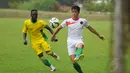 Gelandang Timnas U-23 Indonesia, Gavin Kwan Adsit mencoba mengecoh salah satu pemain asing saat melakukan latih tanding di POR Sawangan, Depok, Rabu (31/12/2014). (Liputan6.com/Helmi Fithriansyah)