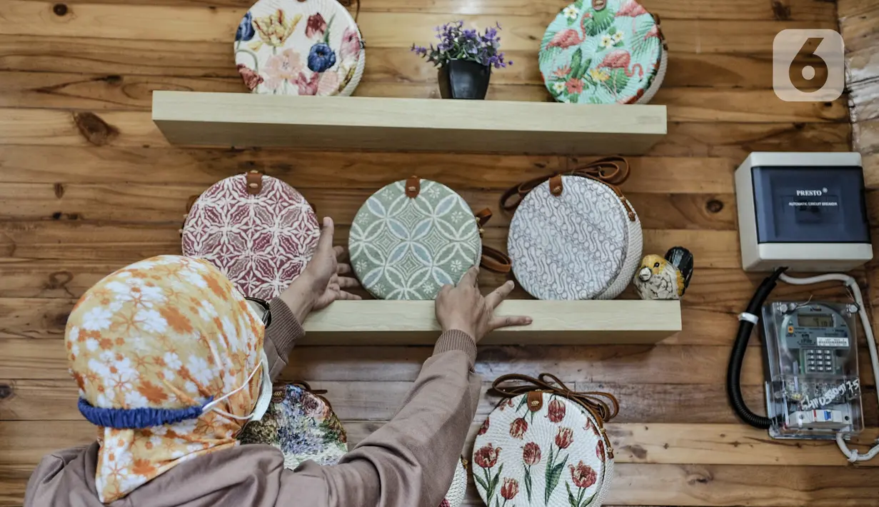 Pengrajin saat merapikan produk yang dijual di Kios Jakpreneur di Jalan Jenderal Sudirman, Jakarta, Rabu (3/2/2021). Terdapat 3 Kios Jakpreneur yang menjual berbagai produk UMKM dalam negeri, mulai dari kerajinan tangan hingga beragam jenis kuliner. (merdeka.com/Iqbal S. Nugroho)