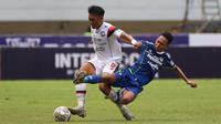 Pemain Persib Bandung, Beckham Putra Nugraha (kanan) berusaha merebut bola dari pemain Arema FC, Rizky Dwi Febrianto pada pertandingan pekan ke-26 BRI Liga 1 2022/2023 yang berlangsung di Stadion Pakansari, Bogor, Kamis (23/2/2023). (Bola.com/Ikhwan Yanuar)