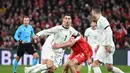 Pemain Portugal, Cristiano Ronaldo, dijaga ketat bek Denmark dalam laga leg pertama perempat final UEFA Nations League 2024/2025 yang digelar di Stadion Parken, Copenhagen, Jumat (21/3/2025) dini hari WIB. (AFP/Jonathan Nackstrand)