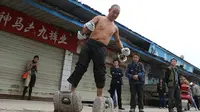 Kakek Huang sering berjalan minimal 200 meter dengan sepatu seberat 70 Kg 
