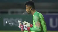 Kiper Timnas Indonesia, Aqil Savik, melepas dahaga saat melawan Thailand pada laga PSSI 88th U-19 di Stadion Pakansari, Jawa Barat, Minggu (23/9/2018). Kedua negara bermain imbang 2-2. (Bola.com/Vitalis Yogi Trisna)