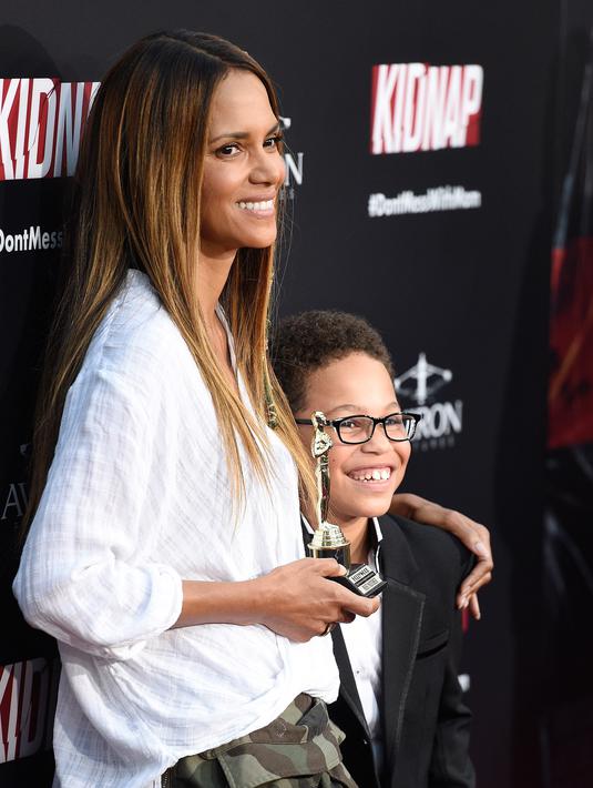 Halle Berry berpose dengan  Sage Correa saat menghadiri pemutaran film barunya "Kidnap" di ArcLight Hollywood di Los Angeles (31/7). Halle Berry tampil dengan ekstensi rambut ombre barunya dan kepang manik-manik. (Photo by Chris Pizzello/Invision/AP)