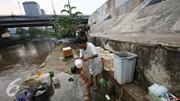 Seorang anak saat mandi di dekat sungai di kawasan Latuharhari, Jakarta Pusat, Selasa (1/12). PAM Jaya menyatakan pasokan air baku yang ada di Jakarta masih belum memungkinkan untuk diolah menjadi sumber air baku utama. (Liputan6.com/Immanuel Antonius)