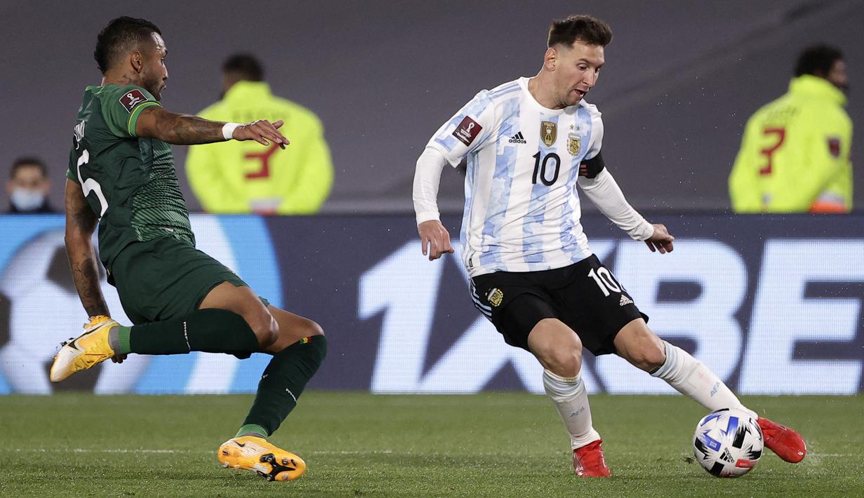 Bek Bolivia, Adrian Jusino berebut bola dengan penyerang Argentina, Lionel Messi pada Kualifikasi Piala Dunia 2022 zona Amerika Selatan, di Stadion El Monumentttal, Jumat (10/9/2021). Hat-trick Lionel Messi membuat Argentina menang 3-0 atas Bolivia. (Juan Ignacio RONCORONI/POOL/AFP)