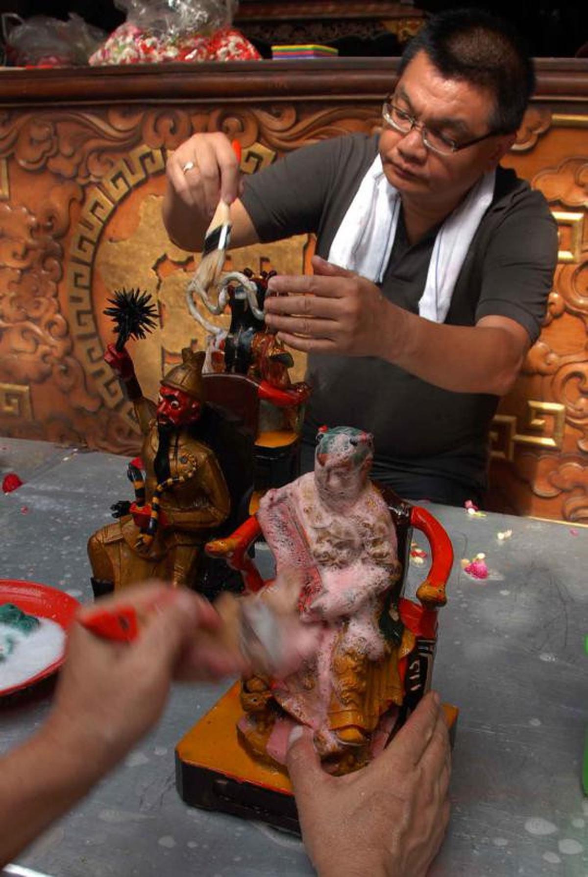 Memandikan patung dewa jelang perayaan Imlek