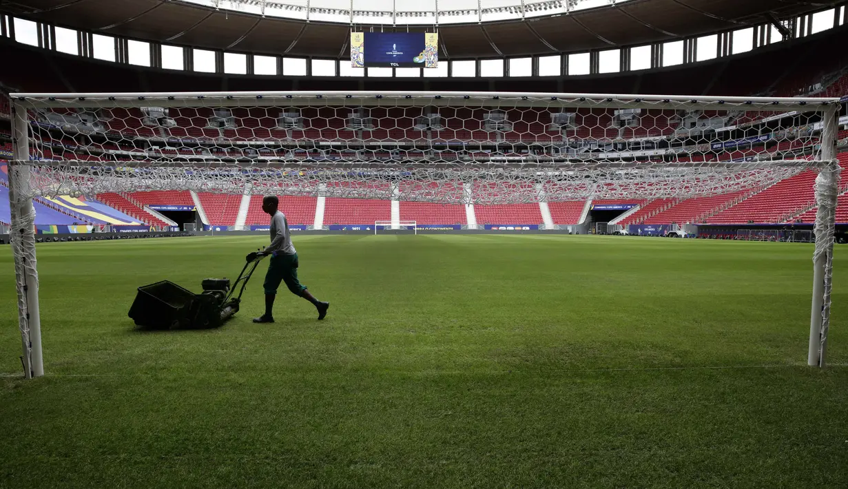 Pekerja mempersiapkan National Stadium untuk turnamen sepak bola Copa America di Brasilia, Brasil, Jumat (11/6/2021). Stadion tersebut akan menjadi tuan rumah laga pembukaan pada 13 Juni waktu setempat atau 14 Juni dini hari WIB. (AP Photo/Eraldo Peres)