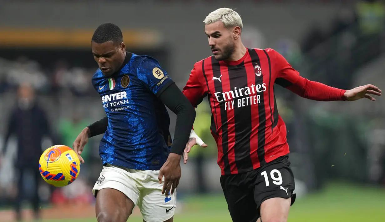 Pemain Inter Milan Denzel Dumfries (kiri) berebut bola dengan pemain AC Milan Theo Hernandez pada pertandingan leg pertama semifinal Coppa Italia di Stadion San Siro, Milan, Italia, 1 Maret 2022. Pertandingan berakhir imbang 0-0. (AP Photo/Antonio Calanni)