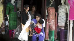 Seorang ibu yang menggendong anaknya terjatuh saat berusaha menyelamatkan diri ketika gempa susulan berkekuatan 7,3 SR kembali mengguncang Nepal, Selasa (12/5/2015). (REUTERS/Athit Perawongmetha)