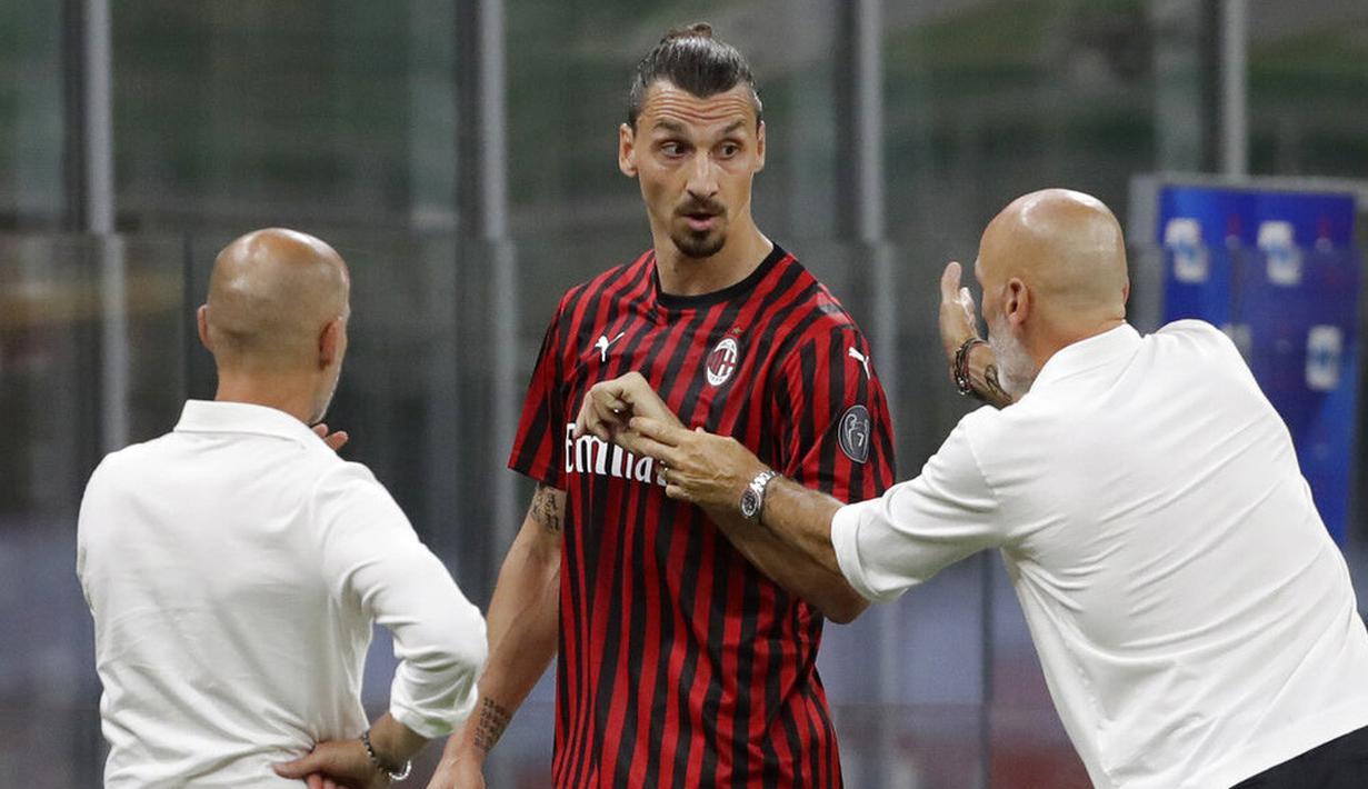 Pelatih AC Milan, Stefano Pioli, berusaha menenangkan Zlatan Ibrahimovic yang kecewa usai diganti saat melawan Bologna pada laga Serie A di Stadion San Siro, Sabtu (18/7/2020). AC Milan menang dengan 5-1 atas Bologna. (AP/Luca Bruno)