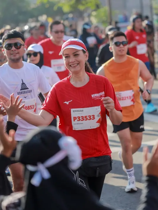 Ira Wibowo tampil dengan busana sporty nuansa merah putih. Ia memadukan jersey merah dengan celana legging hitam. [@irawbw]