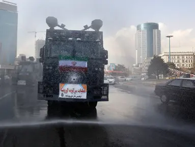 Kendaraan Water Canon kepolisian menyempotkan desinfektan untuk mensterilkan jalan-jalan di Teheran, Iran pada 1 Maret 2020. Sejauh ini, Iran mencatat ada 1.501 kasus virus Corona dengan 66 korban meninggal. (AP Photo/Vahid Salemi)