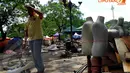 Seorang pedagang Pasar IRTI merapikan dan mengikat patung-patung manekin untuk segera dipindahkan, Selasa (22/4/14). (Liputan6.com/Miftahul Hayat)