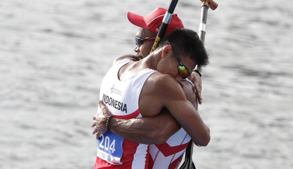 Pasangan Indonesia, Anwar Tara dan Yuda Firmansyah, selebrasi usai menjadi yang tercepat pada SEA Games 2019 cabang kano nomor 1000 meter putra di Subic, Filipina, Jumat (6/12). Pasangan Indonesia berhasil meraih medali emas. (Bola.com/M iqbal Ichsan)