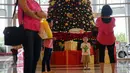 Pengunjung berfoto di dekat pohon natal di Emporium Pluit Mall, Jakarta Utara, Jumat (11/12/2015). Menyambut natal dan tahun baru 2016, Emporium Mall Pluit menyajikan aneka acara untuk menghibur para pengunjung. (Liputan6.com/Faizal Fanani)