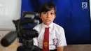 Seorang siswa bersiap untuk difoto saat membuat Kartu Identitas Anak (KIA) di SD Negeri 01 Sawah Baru, Ciputat, Jumat (27/4). KIA ini bermanfaat sebagai bentuk pemenuhan hak anak dan dokumen kependudukan. (Merdeka.com/Arie Basuki)
