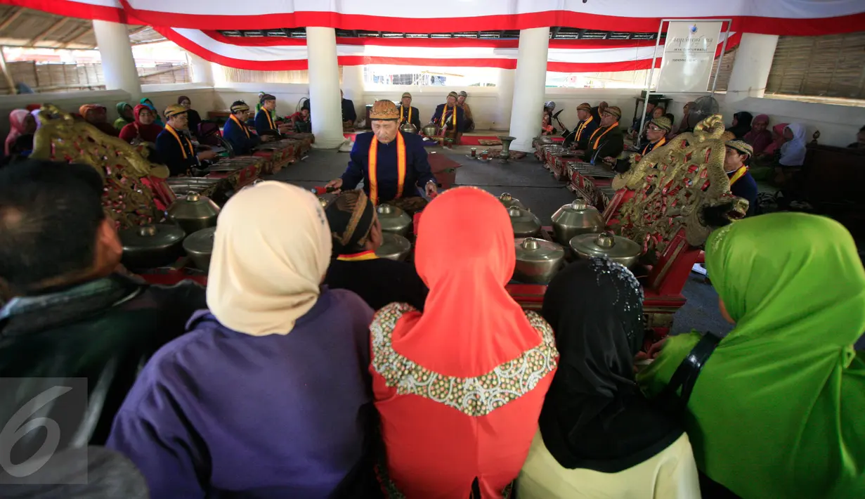 Pengunjung menyaksikan sejumlah abdi dalem memainkan gamelan  sekaten di Bangsal Masjid Agung Kraton Surakarta, (21/12). Acara ini dalam rangka menyambut peringatan hari lahir Nabi Muhammad SAW. (Boy Harjanto)