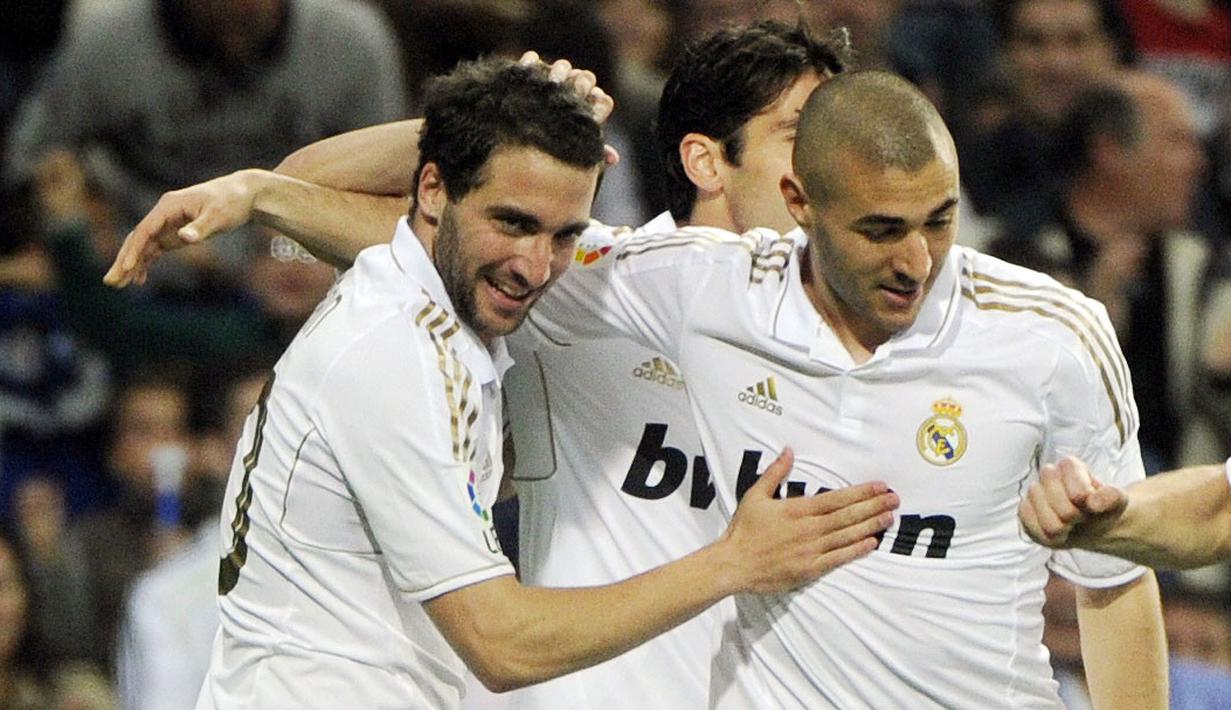 Pemain Real Madrid, Karim Benzema (kanan) merayakan gol bersama rekannya, Gonzalo Higuain (L) pada laga lanjutan Liga Spanyol 2011/2012 melawan Real Sociedad di Stadion Santiago Bernabeu, Madrid, 24 Maret 2012. (AFP/Dominique Faget)