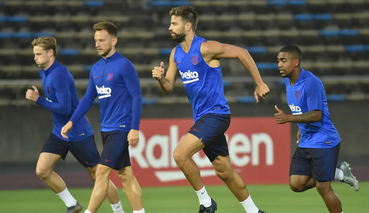 Bek Barcelona, Gerard Pique bersama rekan-rekannya melakukan pemanasan selama sesi latihan di Stadion Atletik Kota Machida di Tokyo (22/7/2019). Barcelona akan bertanding melawan Chelsea pada laga pramusim di ajang trofeo Rakuten Cup 2019 di Stadion Saitama. (AFP Photo/Kazuhiro Nogi)