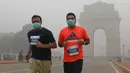 Peserta lari New Delhi 10K menggunakan masker mengikuti lomba ditengah-tengah kabut polusi yang menimpa kota New Delhi, India (6/11). Kabut asap ini diklaim sebagai kabut asap terparah yang dialami oleh New Delhi dalam 17 tahun. (AFP/Dominique Faget)
