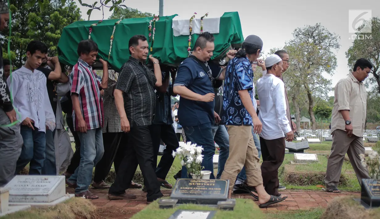 Keluarga menggotong jenazah aktris senior Titi Qadarsih saat akan dimakamkan di TPU Tanah Kusir, Jakarta, Selasa (23/10). Bintang film senior itu meninggal di usia 73 tahun. (Liputan6.com/Faizal Fanani)