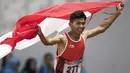 Purnomo Sapto Yogo pelari Indonesia meraih medali emas di nomor 100 meter putra klasifikasi T37 pada Asian Para Games 2018, di Stadion Utama Gelora Bung Karno Jakarta, Selasa (9/10/2018).  (Bola.com/Peksi Cahyo)