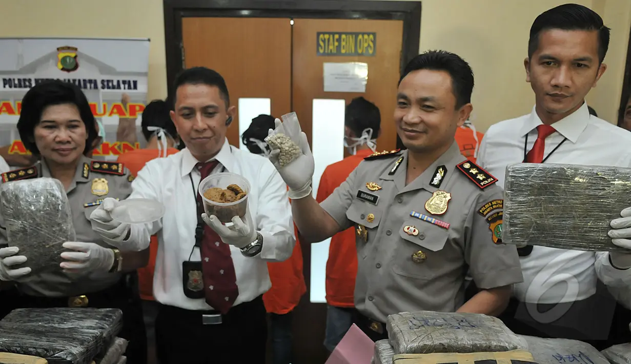 Wakapolres Metro Jakarta Selatan, AKBP Surawan (kedua kanan) memperlihatkan barang bukti pil ekstasi yang disita dari enam orang tersangka dengan tiga kasus berbeda di Mapolres Jakarta Selatan, Senin (27/4/2015). (Liputan6.com/Johan Tallo)