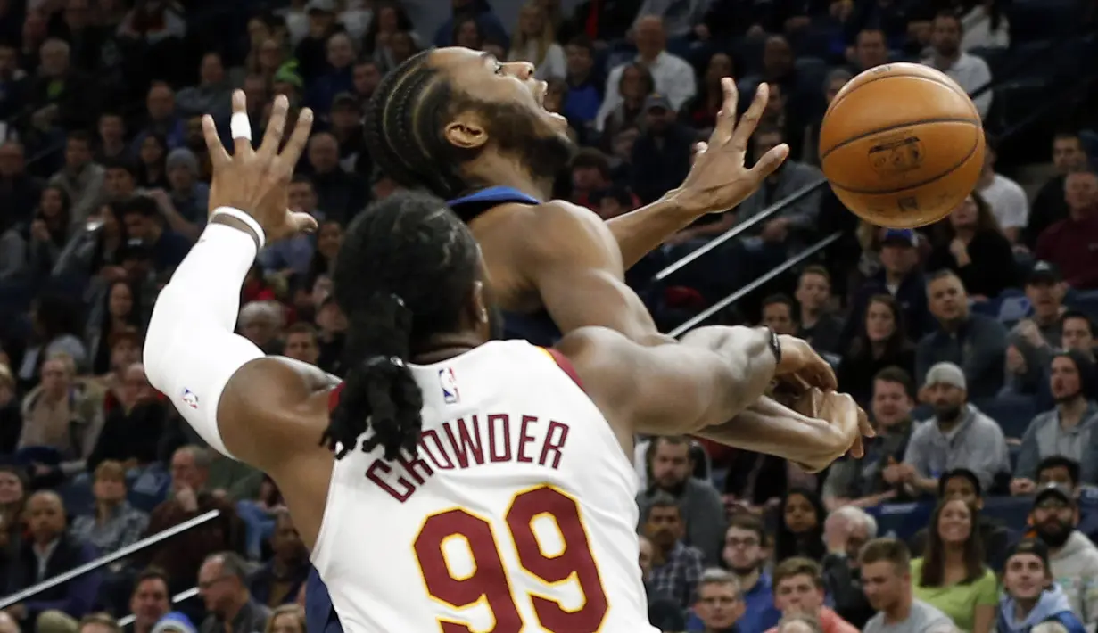 Pemain Minnesota Timberwolves, Andrew Wiggins (atas) gagal melewati adangan pemain Cleveland Cavaliers, Jae Crowder (99) pada laga NBA basketball game di Target Center, Minneapolis, (8/1/2018). Minnesota menang 127-99. (AP/Jim Mone)