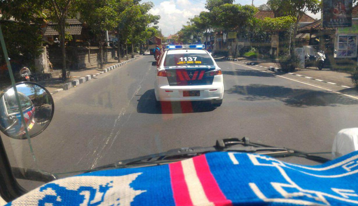 Truk pengangkut bendera merah putih raksasa bertajuk One Soul One Nation dan Aremania mendapat pengawalan polisi Polda Bali menuju ke Gianyar. (Bola.com/Aremania)