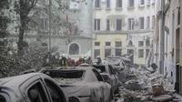 Petugas layanan darurat berkumpul di luar bangunan yang rusak saat pencarian korban berlanjut setelah serangan rudal Rusia di Lviv, Ukraina, Kamis, 6 Juli 2023. (AP Photo/Mykola Tys)