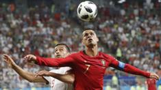 Duel pemain Portugal, Cristiano Ronaldo (kanan) dan pemain Iran, Omid Ebrahimi pada laga grup B Piala Dunia 2018 di Mordovia Arena, Saransk, Rusia, (25/6/2018). Portugal dan Iran bermain imbang 1-1. (AP/Pavel Golovkin)