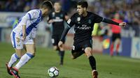 Aksi pemain Real Madrid, Marco Asensio (kanan) mengecoh pemain Leganes, Unai Bustinza pada lanjutan La Liga Santander di Butarque stadium, Leganes, (21/2/2018). Real Madrid menang 3-1.  (AP/Francisco Seco)