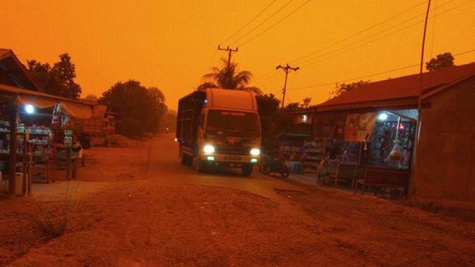 Potret Langit Merah di Jambi Akibat Kabut Asap, Siang Gelap Bak Malam Hari (sumber: Merdeka.com)
