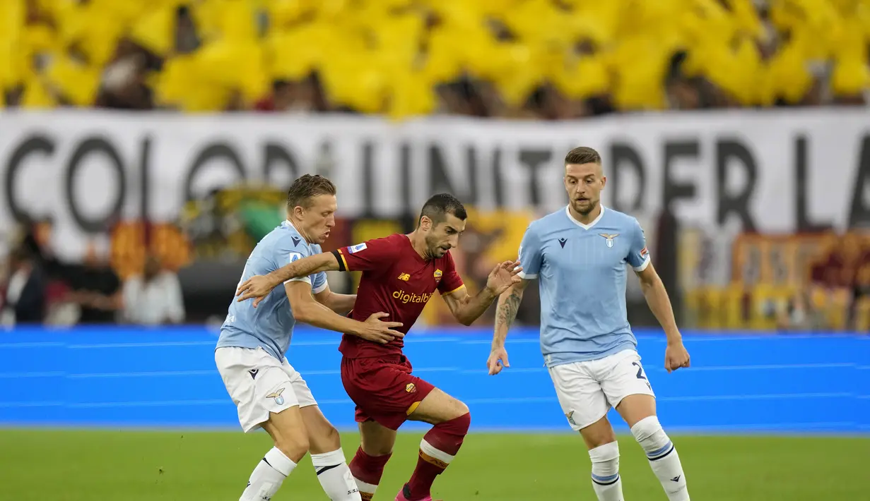 Gelandang Lazio, Lucas Leiva berusaha merebut bola gelandang AS Roma, Henrikh Mkhitaryan pada pertandingan lanjutan Liga Serie A Italia di Stadion Olimpiade Roma, Senin (27/9/2021). Lazio menang tipis atas Roma dengan skor 3-2. (AP  Photo/Andrew Medichini)