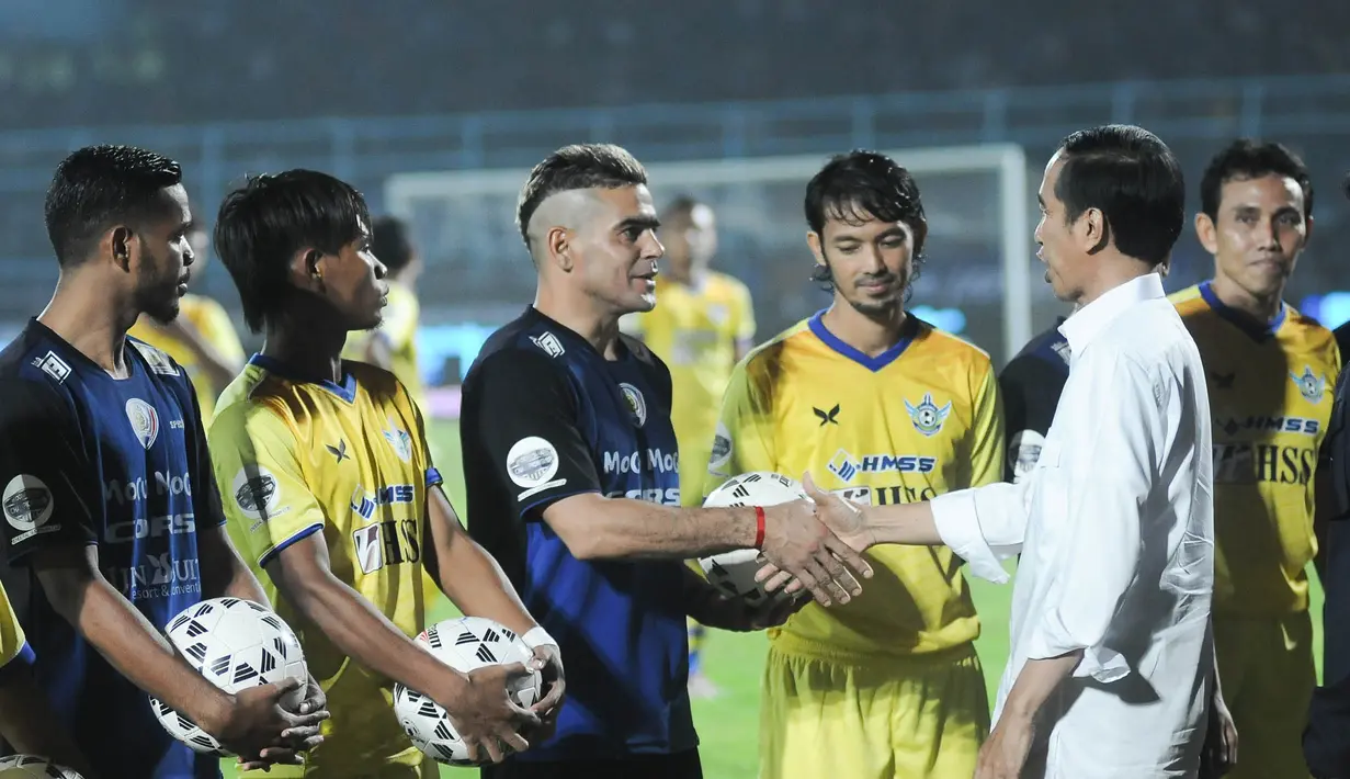 Presiden Joko Widodo bersalaman dengan penyerang Arema Cronus, Cristian Gonzales jelang laga pembukaan Piala Jenderal Sudirman melawan Persegres G.U di Stadion Kanjuruhan, Malang, Selasa (10/11/2015). (Bola.com/Kevin Setiawan)