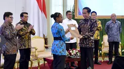Presiden Joko Widodo menerima dokumen dari salah satu Peserta Kongres Indonesia Millenial Movement Tahun 2018 di Istana Bogor, Jawa Barat, Senin (12/11). (Liputan6.com/Pool/Laily Rachev-Biro Pers Setpres)
