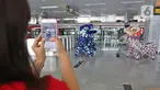 Penumpang dan pengguna jasa mengambil gambar pertunjukan barongsai di Stasiun LRT Velodrome (25/1/2020). Pertunjukan tersebut dalam rangka perayaan tahun baru Imlek yang ke-2571. (Liputan6.com/Herman Zakharia)