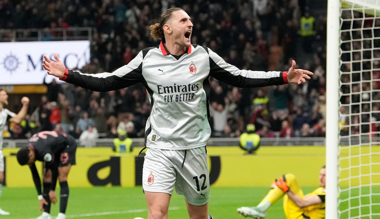 Pemain AC Milan, Adrien Rabiot, melakukan selebrasi setelah mencetak gol ke gawang Torino pada laga Liga Italia di Stadion San Siro, Minggu (22/3/2026) dini hari WIB. (AP Photo/Luca Bruno)